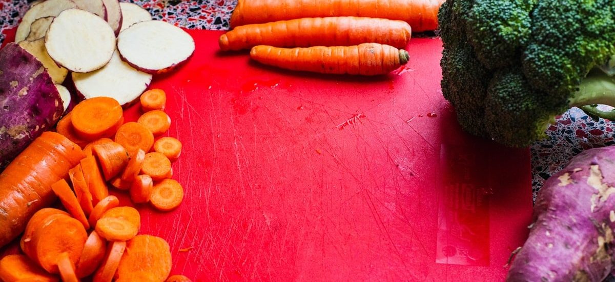 sliced carrots on red board